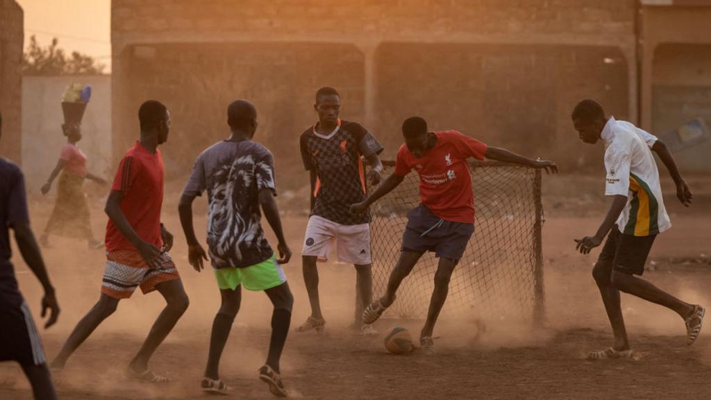 People play football in korhogo, northern Ivory Coast on January 17, 2024 as the country hosts the Africa Cup of Nations (CAN) 2024