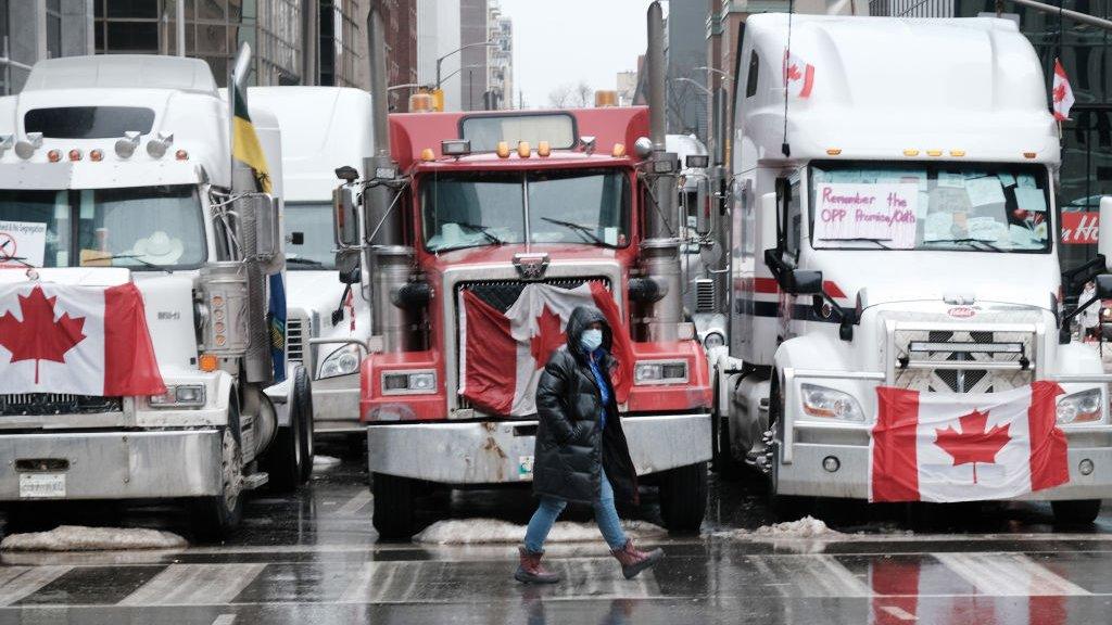 A pedestrian near the protest trucks