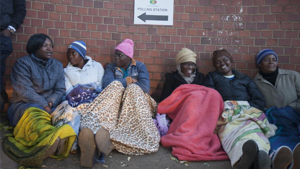 People wait in line before they cast their ballots during general election in Harare, Zimbabwe on July 30, 2018.