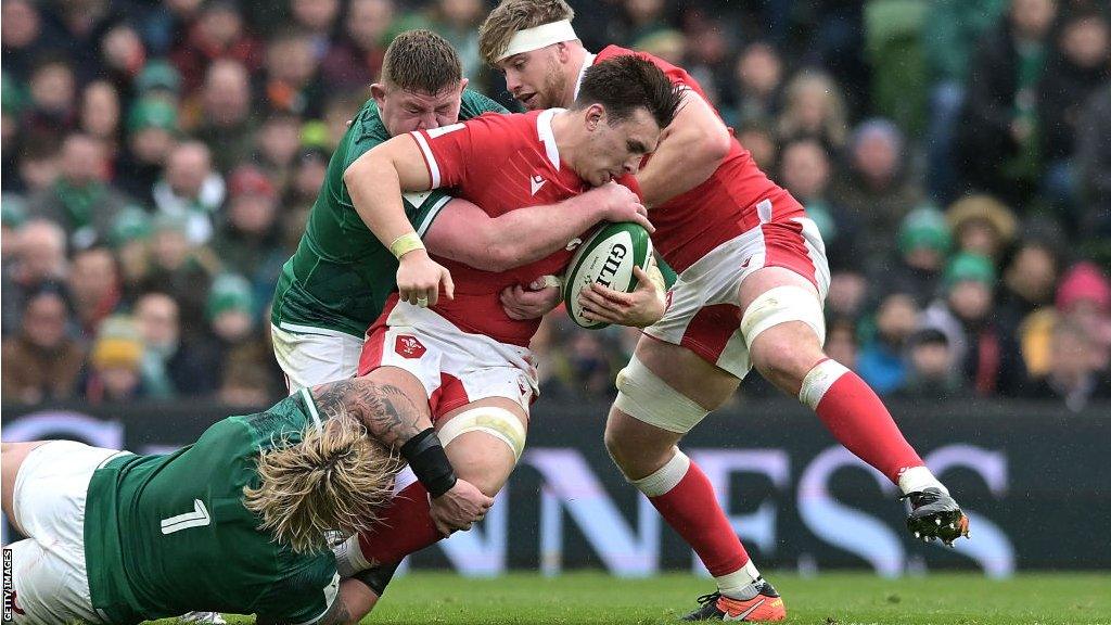 Taine Basham tackled by Ireland players