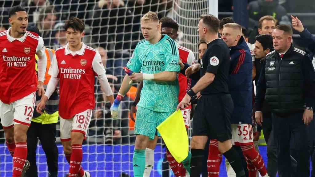 Aaron Ramsdale being led away by the referee after the incident involving a Tottenham fan