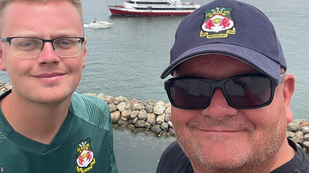 Wrexham fans Jason Roberts (right) and his son Owen