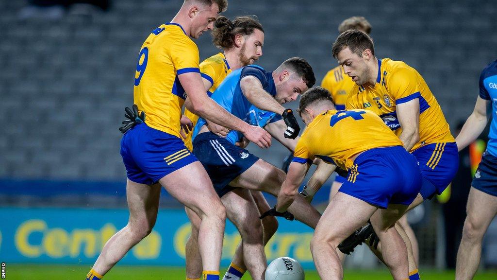 Clare players surround Dublin's Ross McGarry during an Allianz Football League game last year