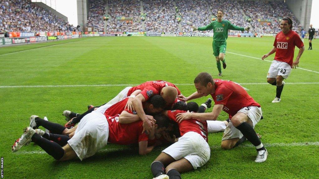 Manchester United players celebrate a goal on the final day