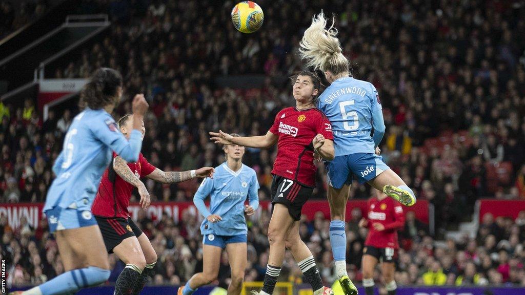 Alex Greenwood wins a header