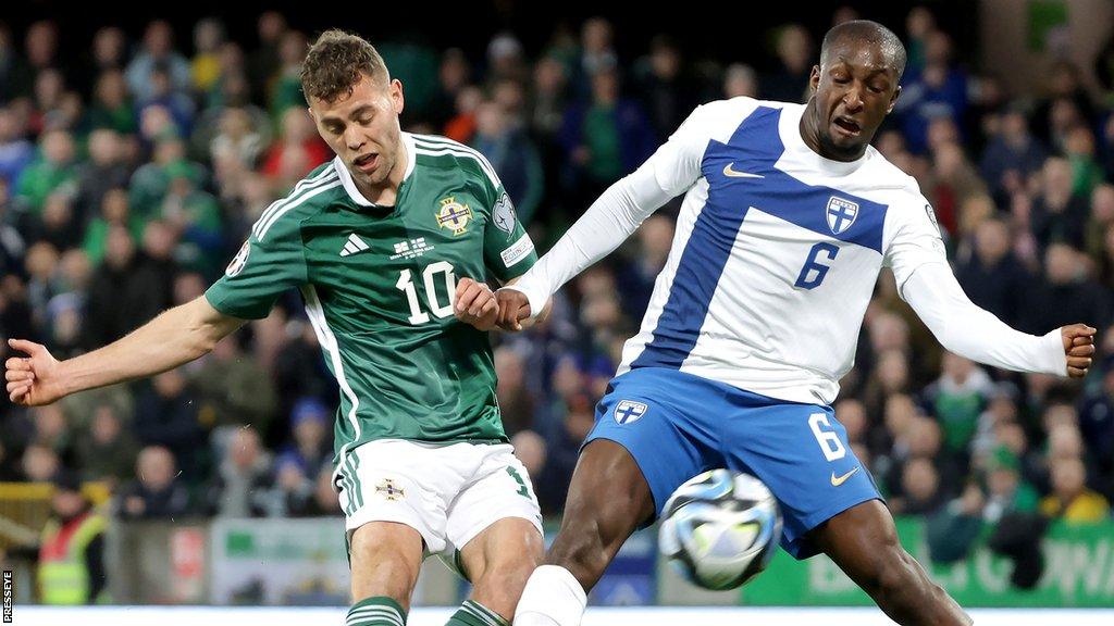 NI striker Dion Charles in action against Finland's Glen Kamara