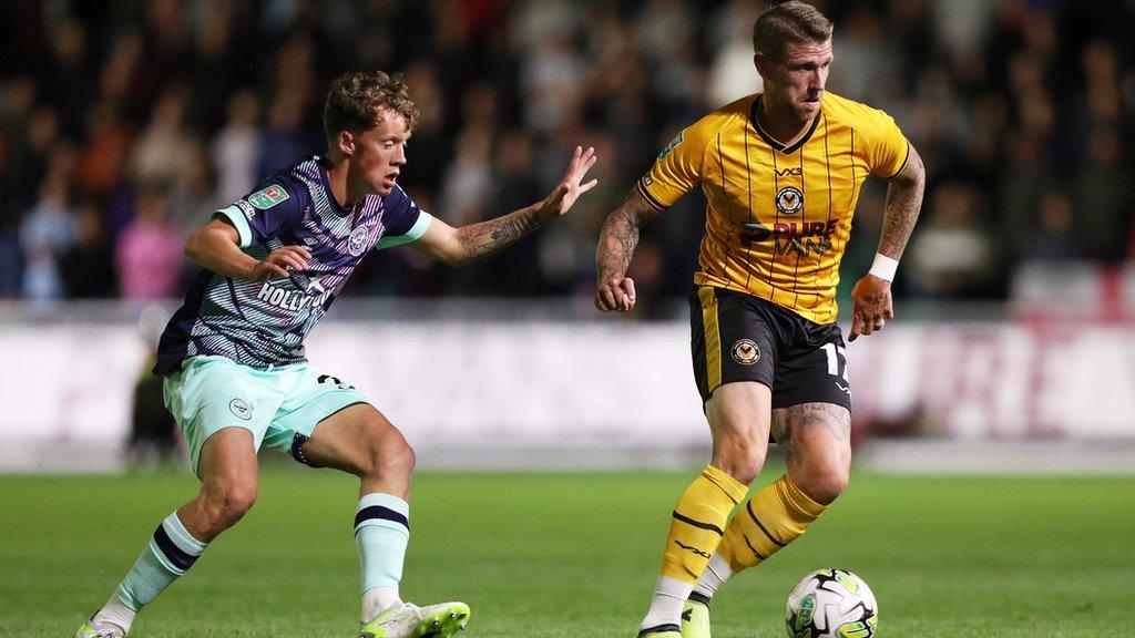 Scot Bennett of Newport County on the ball ahead of Ethan Brierley of Brentford