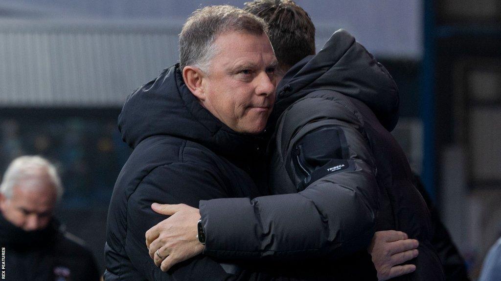 Mark Robins was consoled by Ipswich Town boss Kieran McKenna after Saturday's defeat