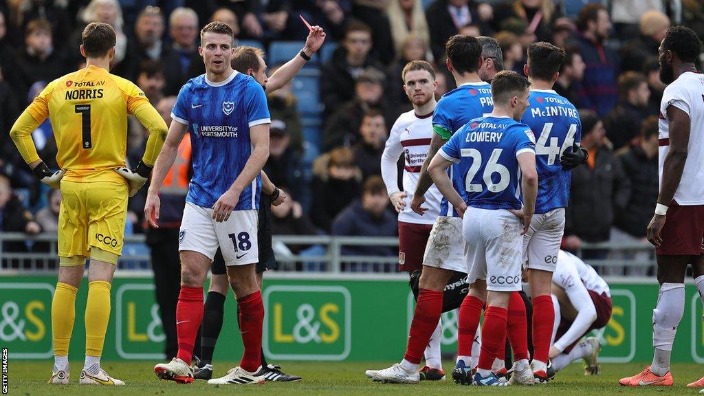 Portsmouth defender Tom McIntyre is shown a red card by referee Sam Purkiss in their League One win over Northampton