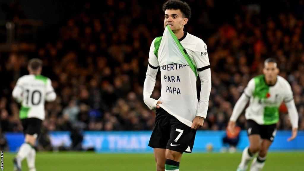 Luis Diaz lifts a shirt revealing a message saying "Freedom for Papa"