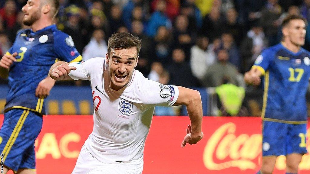 Harry Winks celebrates a goal for England