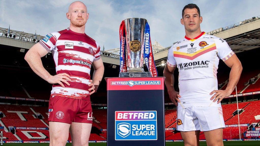 Wigan captain Liam Farrell and Catalans captain Ben Garcia stand aside the Super League trophy