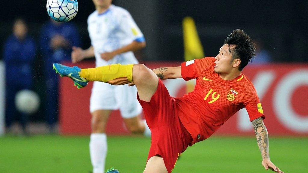 China's Zhang Xizhe kicks the ball during the World Cup football qualifying match between China and Uzbekistan in Wuhan in China's central Hubei province on August 31, 2017