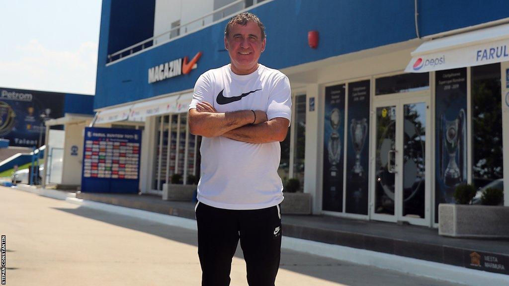 Gheorghe Hagi standing outside Academia Hagi