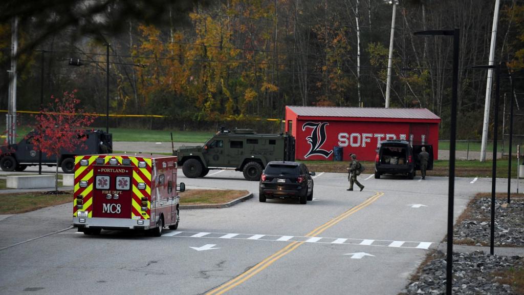 Police, staged at the Lisbon High School, clear out of the area as an active search for a gunman is underway after Lewiston's deadly mass shootings