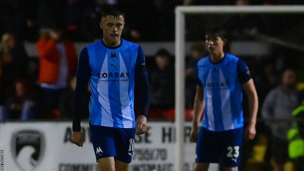 Torquay's players look dejected after the final whistle