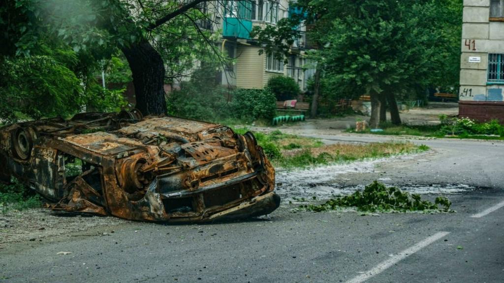 A burned out car in the city of Severodonetsk in May 2022