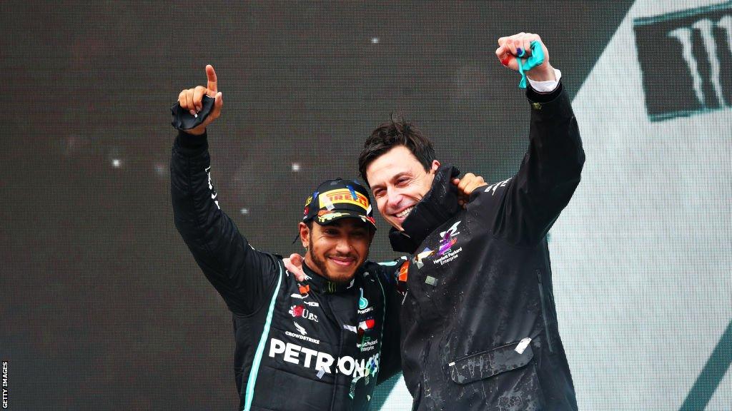 Lewis Hamilton celebrates winning a seventh F1 world title with Mercedes GP team principle Toto Wolff