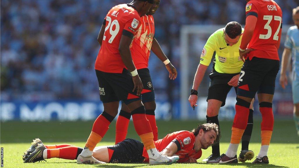 Luton's Tom Lockyer after collapsing on the Wembley pitch