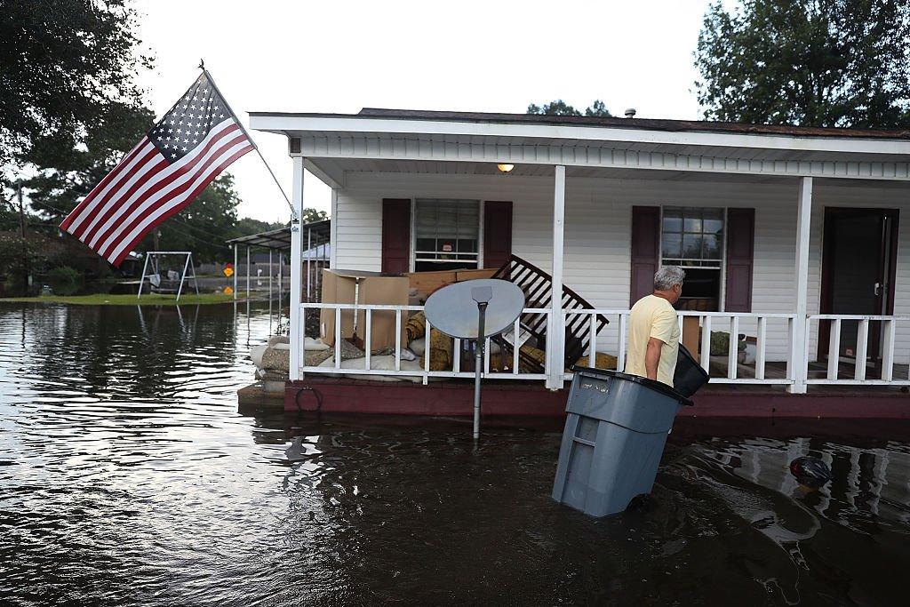 House with US flag in flood