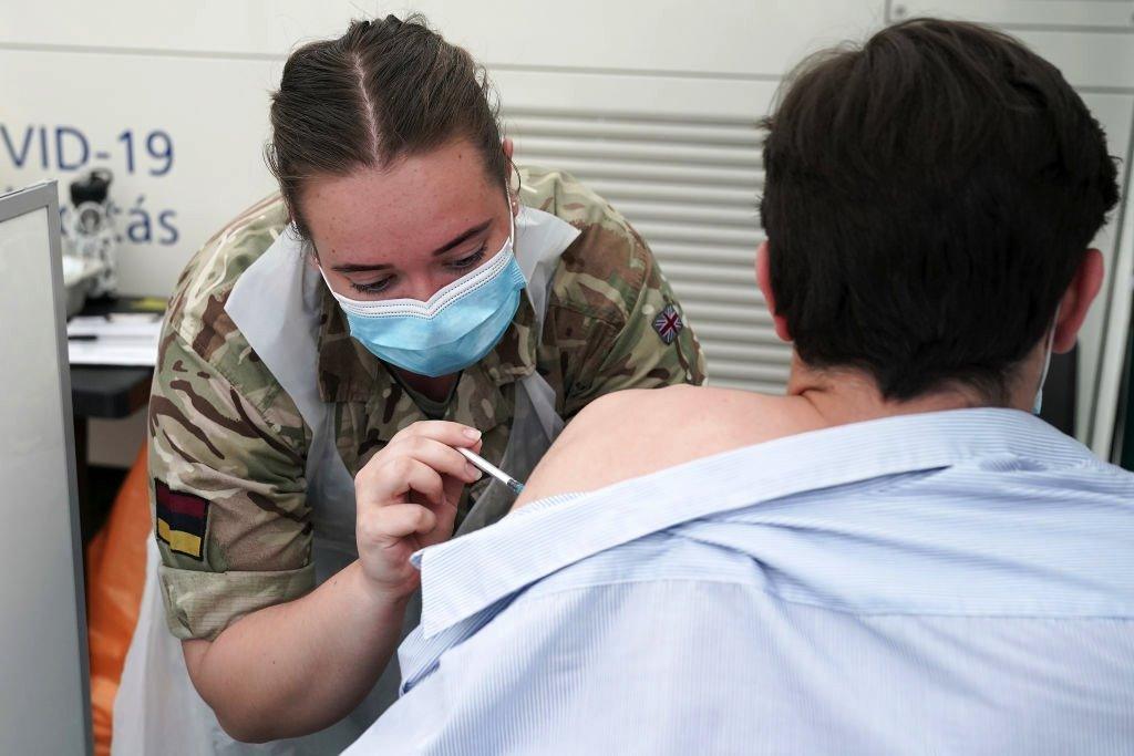 Combat medics from Queen Alexandra's Royal Army Nursing Corps vaccinate members of the public at a rapid vaccination centre