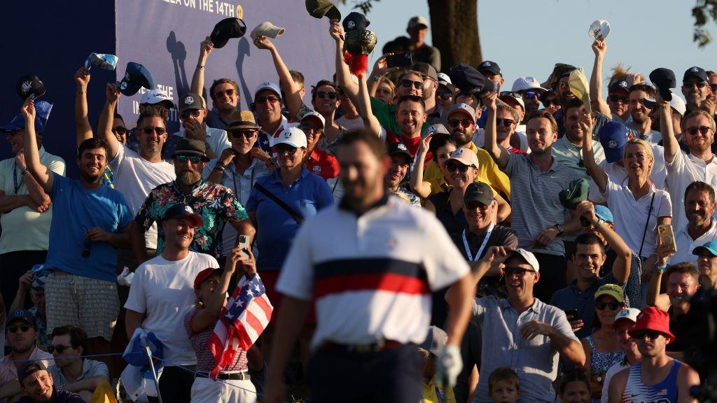 Patrick Cantlay walking in front of hat-waving European fans