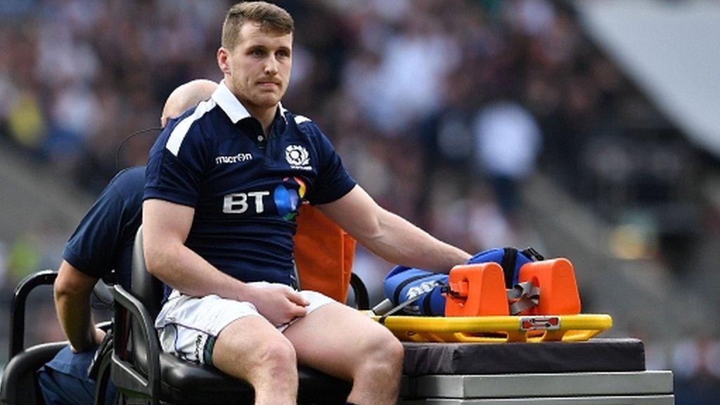 Scotland centre Mark Bennett is taken off on a cart at Twickenham