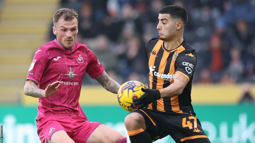 Josh Tymon of Swansea City and Anass Zaroury of Hull City