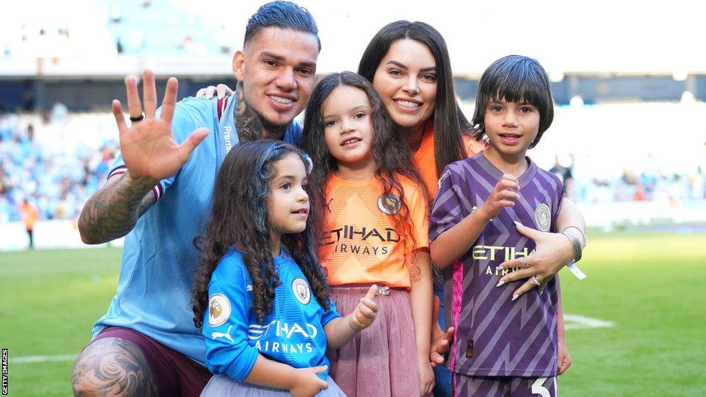 Ederson celebrates with his family on the pitch