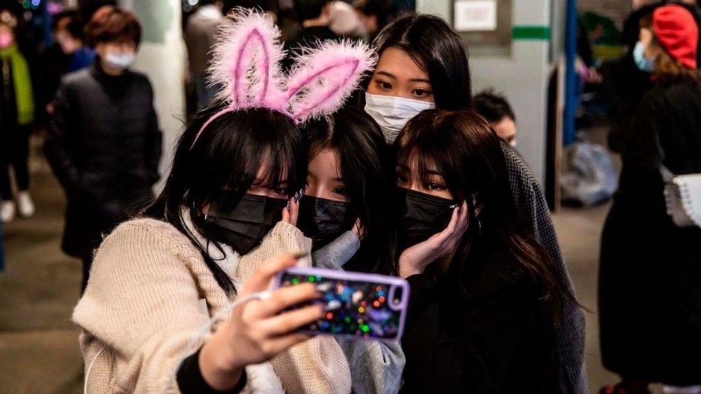 Chinese women posing for a photo