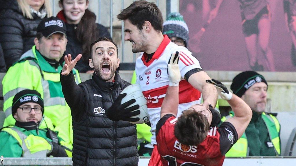 Down manager Conor Laverty reacts as Derry's Chrissy McKaigue lashes out at Ceilum Doherty