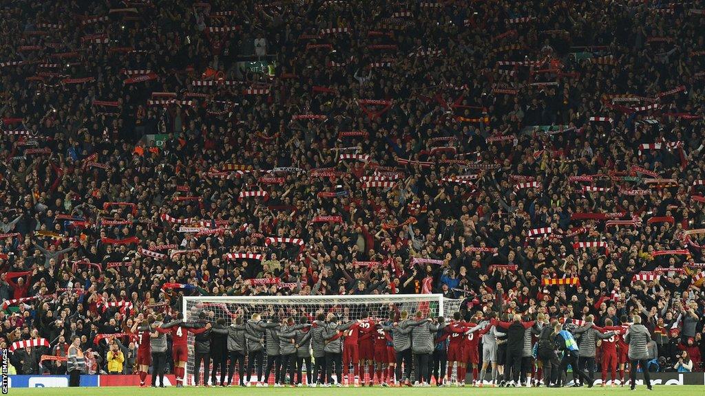 Liverpool squad and backroom staff celebrate in front of the Kop after winning the Champions league semi-final second leg between Liverpool and Barcelona 4-0 at Anfield in May 2019