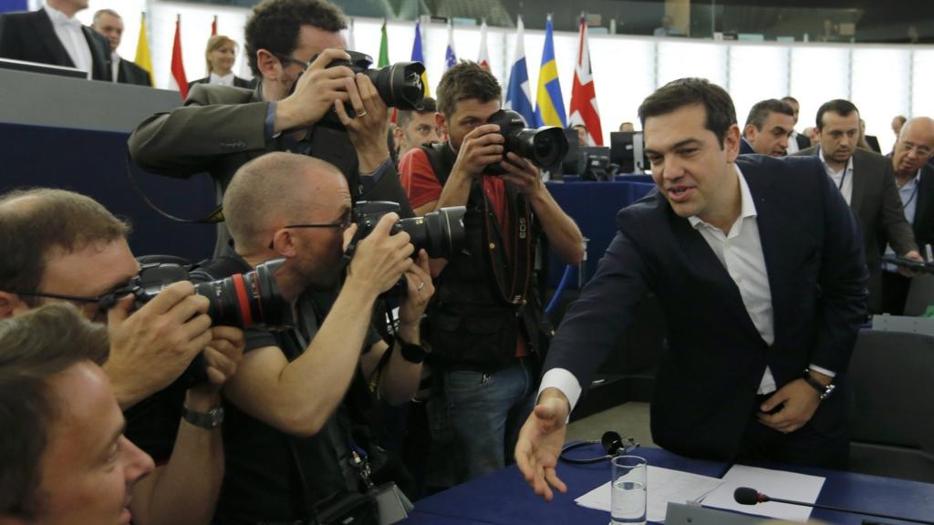 Alexis Tsipras (R) shakes hands with a Member of the European Parliament on 8 July