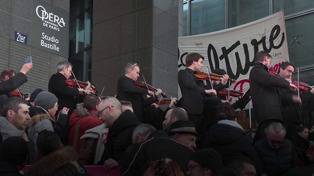 Musicians of the Paris opera orchestra stage an impromptu concert outside the Bastille opera