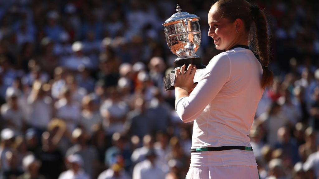 Jelena Ostapenko of Latvia celebrates with the trophy