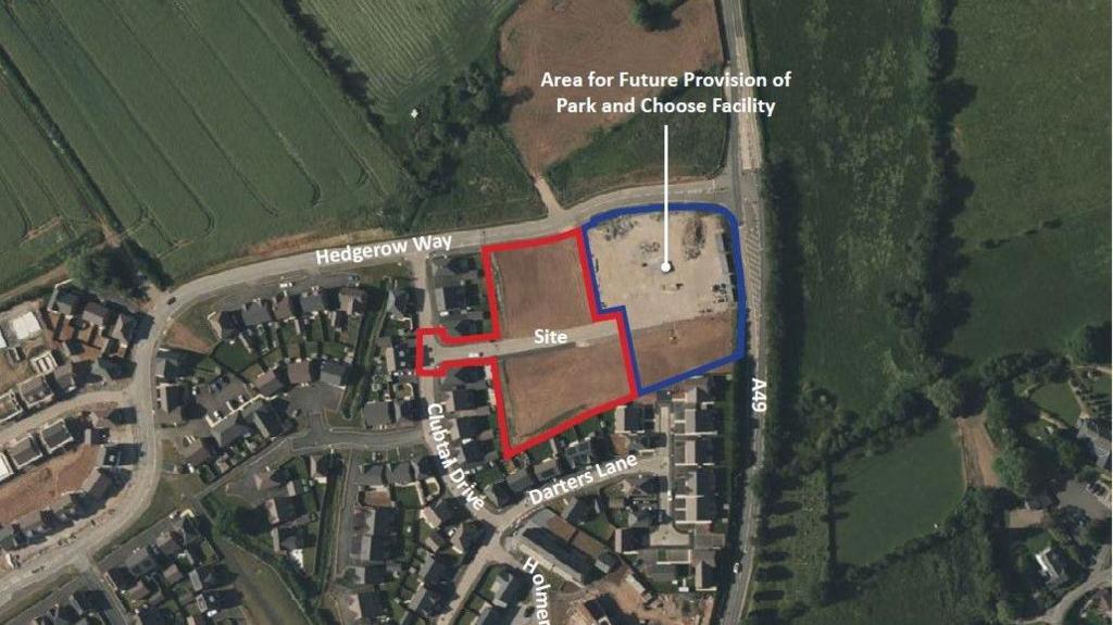 An aerial map that shows a housing estate next to green belt. A small area of undeveloped land is highlighted with a red perimeter to demonstrate an area where housing plans have been revealed, with a space to the right highlighted in blue where a park and ride site is planned. 