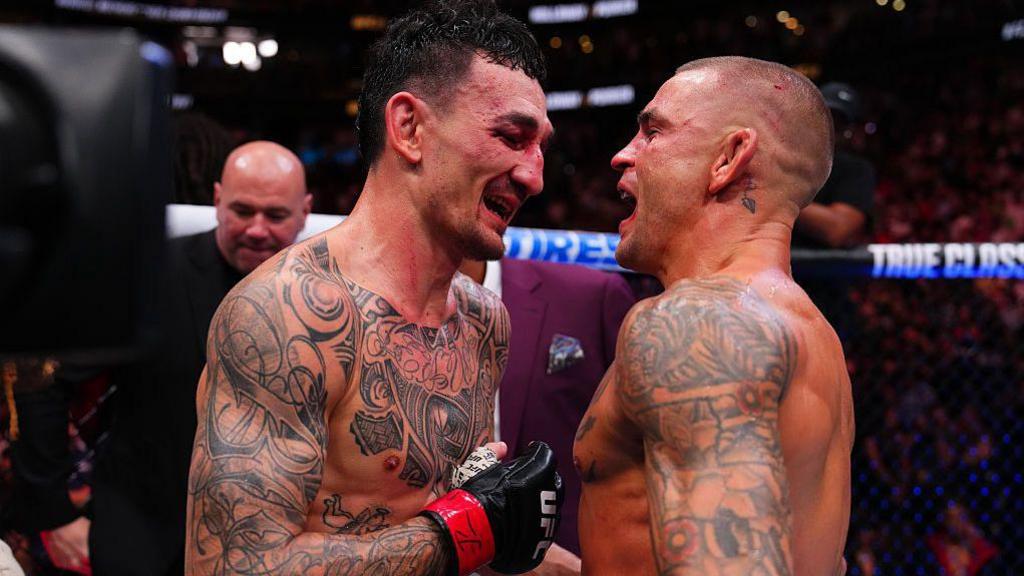 Max Holloway and Dustin Poirier embrace after UFC 318