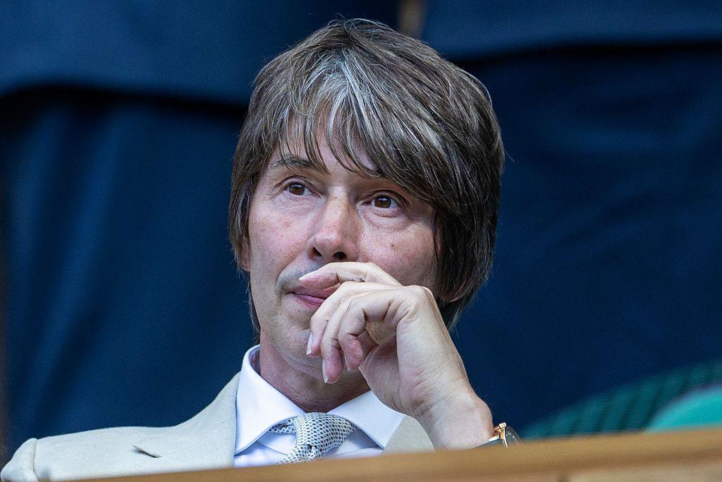 Professor Brian Cox with his hand to his face, appearing as if in thought. 