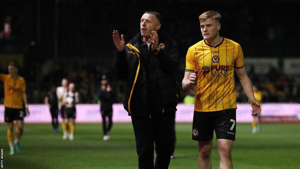 Newport County boss Graham Coughlan applauds with Will Evans