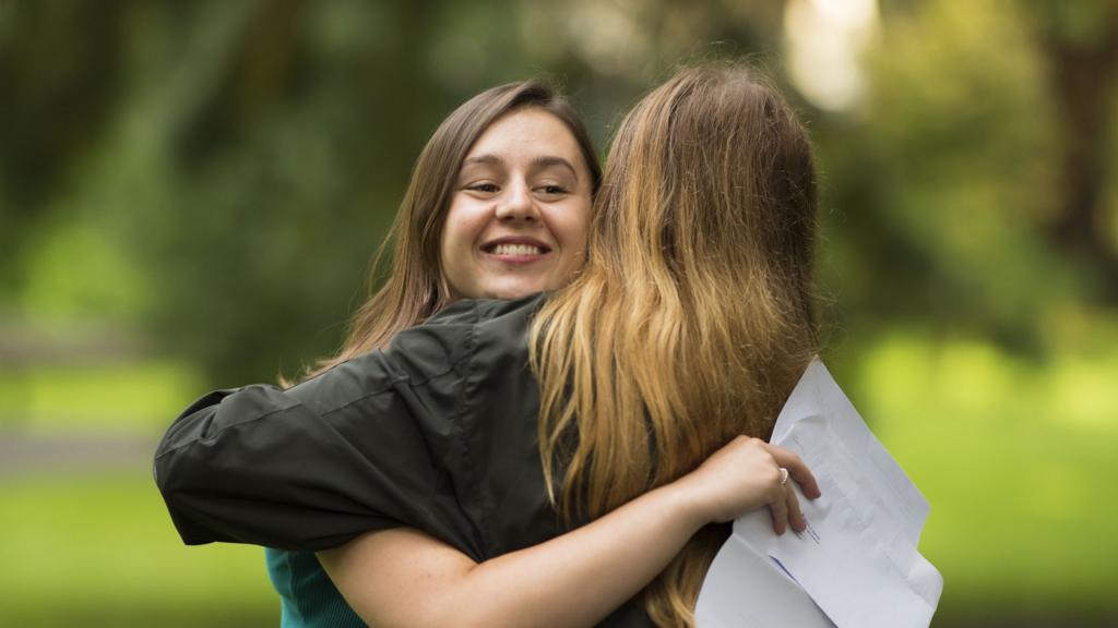 Caitlin Hannah hugs a fellow pupil after receiving 2 As and an A* in her A Level results at Ffynone House School on August 17, 2017 in Swansea