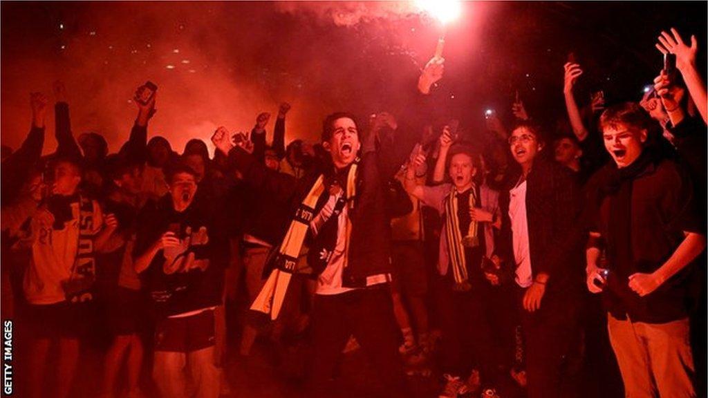 Australian fans celebrate in Melbourne on December 1, 2022, after Australia's victory over Denmark