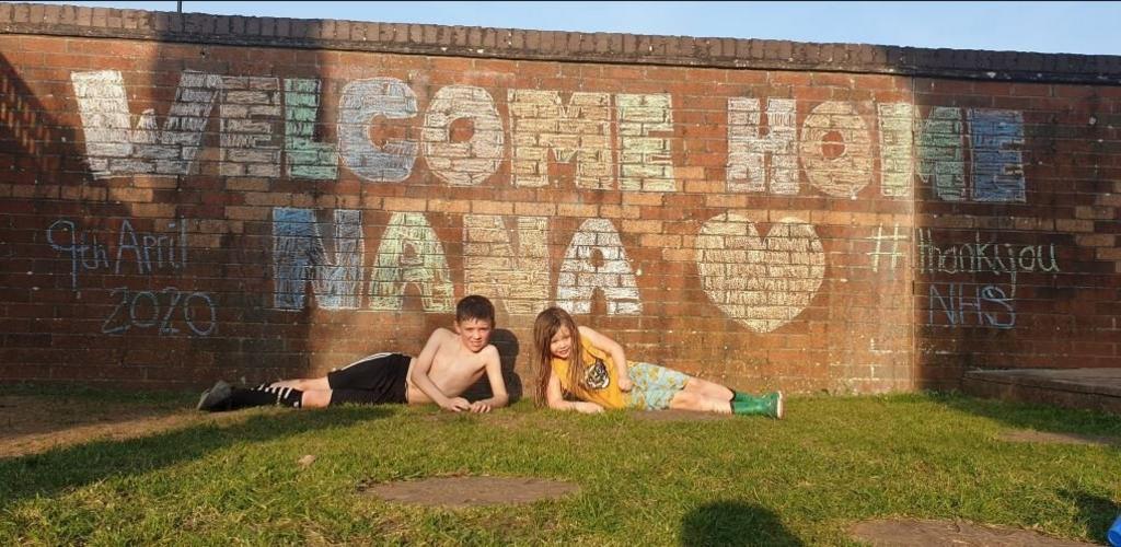 Angie Shell's grandchildren with a stencilled message for their grandmother