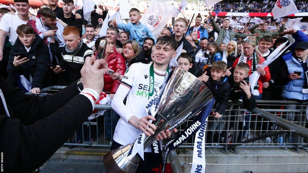 Conor Bradley celebrates with the Papa John's Trophy