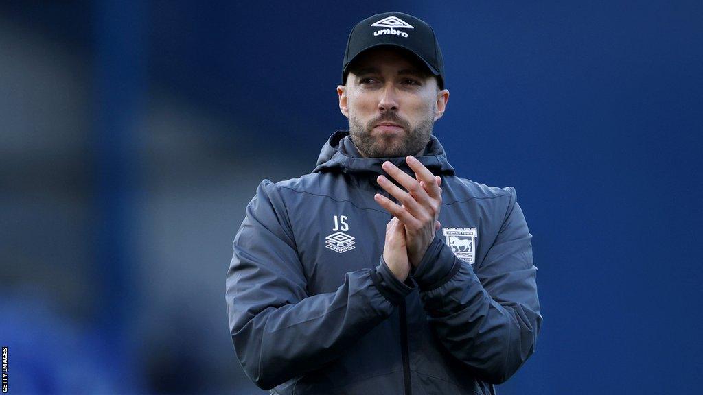 Ipswich boss Joe Sheehan applauds the crowd at the end of Saturday's game