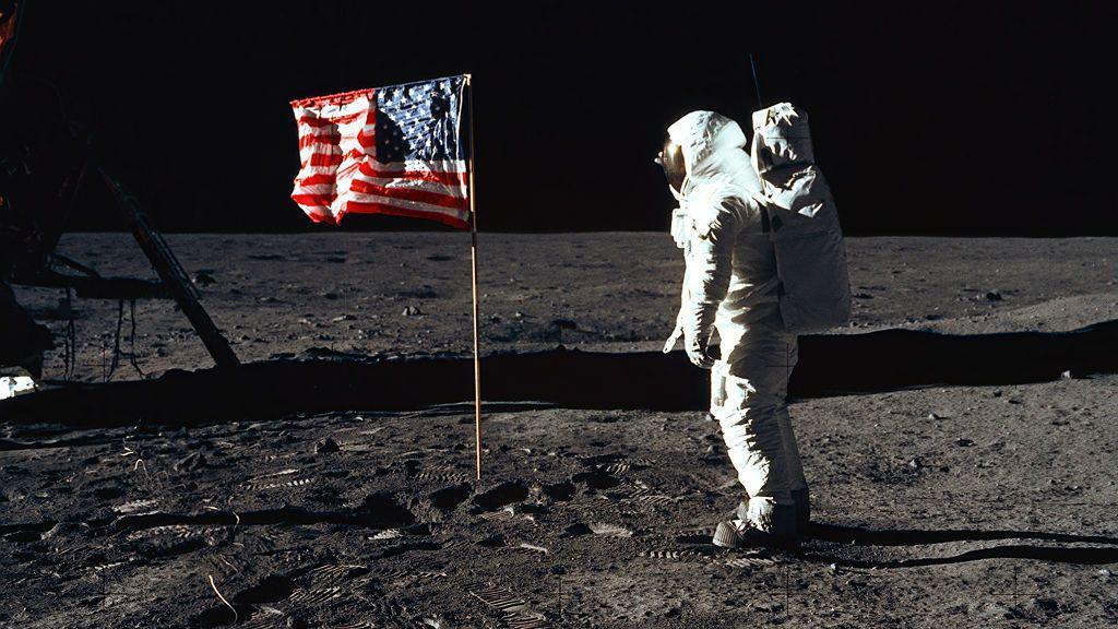 Astronaut Edwin E. "Buzz" Aldrin, Jr., beside the U.S. flag during an Apollo 11 moon walk 