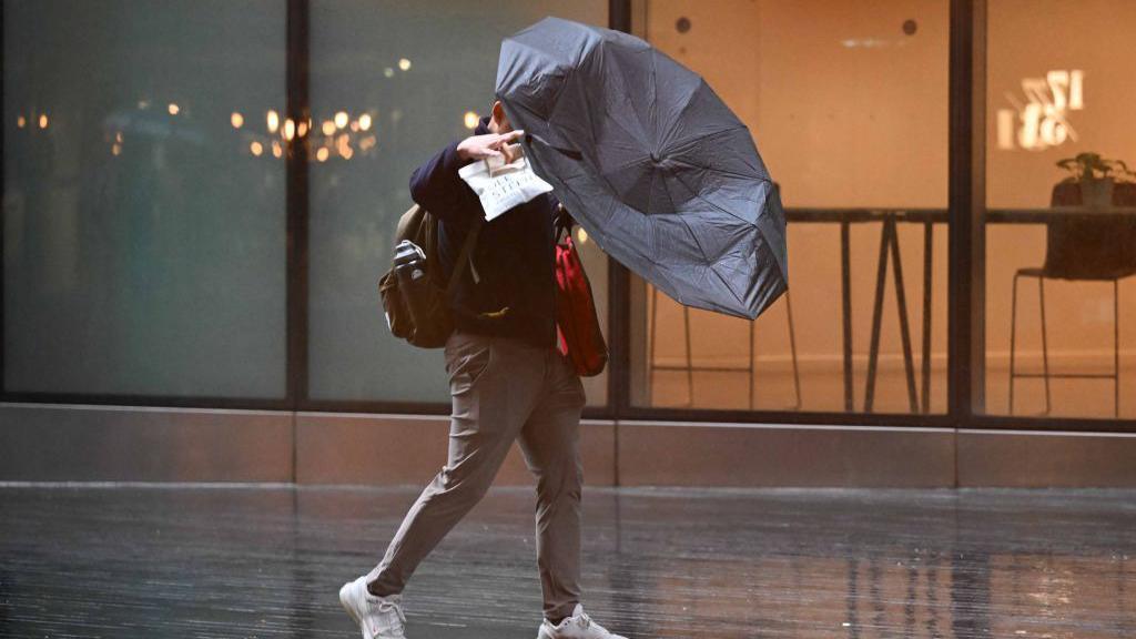 man with umbrella turned inside out.