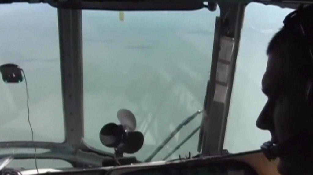 Man in cockpit of search plane