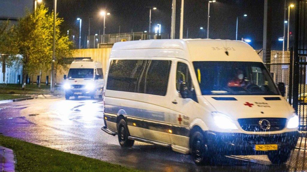 Passengers from South Africa flight being driven away to hotel quarantine at Schiphol airport