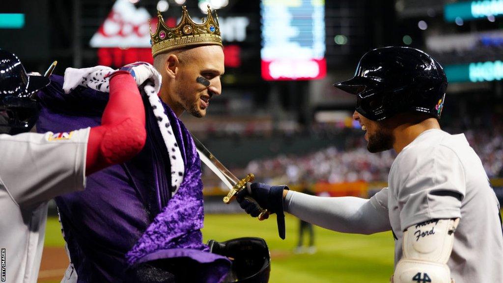 Trayce Thompson of Team Great Britain is given a crown and robe after hitting a home run in the first inning during the Pool C game between Great Britain and the USA at Chase Field