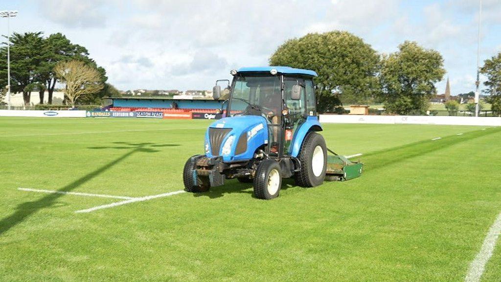 A tractor tends to the playing surface at Jersey Reds